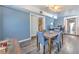 Open dining room features hardwood floors, a modern light fixture, and multiple entrances at 505 Hedge Row Rd, Brandon, FL 33510