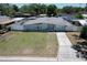 This aerial view shows a lovely home with a well-kept lawn and convenient driveway at 505 Hedge Row Rd, Brandon, FL 33510