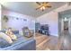 Cozy living room features hardwood floors, a ceiling fan, and stylish furniture at 505 Hedge Row Rd, Brandon, FL 33510