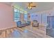 Bright living room with large windows, cozy seating, and hardwood floors at 505 Hedge Row Rd, Brandon, FL 33510