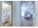 Hallway view of Primary bedroom with double sinks in en-suite bathroom and comfortable chaise lounge at 505 Hedge Row Rd, Brandon, FL 33510