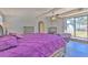 Bright Primary bedroom boasts hardwood flooring, natural lighting, and a sliding glass door at 505 Hedge Row Rd, Brandon, FL 33510