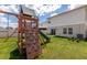 Spacious backyard featuring a large playground with climbing wall and slide at 34327 Verbena St, Wesley Chapel, FL 33545
