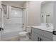 Bright bathroom featuring a shower-tub combo, vanity with white countertop, and modern fixtures at 34327 Verbena St, Wesley Chapel, FL 33545