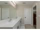 Bright bathroom showcasing double sinks, modern fixtures, and tile flooring at 34327 Verbena St, Wesley Chapel, FL 33545