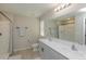 Bright bathroom featuring double sinks, modern fixtures, and walk-in shower at 34327 Verbena St, Wesley Chapel, FL 33545