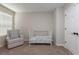 Comfortable bedroom featuring a crib and wingback chair with black hardware at 34327 Verbena St, Wesley Chapel, FL 33545