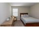 Well-lit bedroom featuring a bed with a patterned headboard, wooden dresser, and a window at 34327 Verbena St, Wesley Chapel, FL 33545