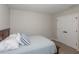 Comfortable bedroom featuring a queen bed, plush pillows, and a convenient double door closet at 34327 Verbena St, Wesley Chapel, FL 33545