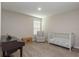 Comfortable bedroom featuring a crib, wingback chair, and piano, perfect for a Bedroom at 34327 Verbena St, Wesley Chapel, FL 33545