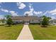 Exterior shot of the community clubhouse surrounded by manicured landscaping and lawn at 34327 Verbena St, Wesley Chapel, FL 33545