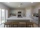 Modern kitchen with island, seating, stainless steel appliances, and light gray cabinets at 34327 Verbena St, Wesley Chapel, FL 33545