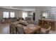 Open concept living and dining area with wood floors and many windows for natural light at 34327 Verbena St, Wesley Chapel, FL 33545