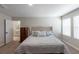 Bright main bedroom featuring plush carpeting, dresser and access to the bathroom at 34327 Verbena St, Wesley Chapel, FL 33545