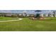Community playground featuring a play structure under an umbrella near a walking path at 34327 Verbena St, Wesley Chapel, FL 33545