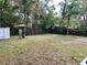 View of spacious backyard with chain link fence, trees, and storage shed, perfect for outdoor activities at 4213 Temple Heights Rd, Tampa, FL 33617