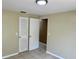 Bedroom with tile floor, neutral walls and a louvered door closet at 4213 Temple Heights Rd, Tampa, FL 33617