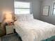 Cozy bedroom featuring a well-lit window, comfortable queen bed, and a nightstand with lamp at 4213 Temple Heights Rd, Tampa, FL 33617