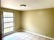 A bright bedroom with natural light, neutral walls, and tile flooring at 4213 Temple Heights Rd, Tampa, FL 33617