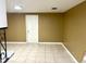 An empty living room featuring tile flooring, tan walls, and a centered ceiling light at 4213 Temple Heights Rd, Tampa, FL 33617