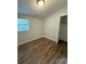 Bedroom featuring modern floors, gray walls, blinds and a closet with open door at 4617 John Bell Jr Dr, Tampa, FL 33610