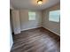 Bedroom with hardwood floors, closet and windows overlooking backyard at 4617 John Bell Jr Dr, Tampa, FL 33610