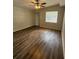 Bedroom featuring vinyl floors, a window and a ceiling fan at 4617 John Bell Jr Dr, Tampa, FL 33610
