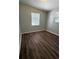 Cozy bedroom featuring modern flooring and plenty of light at 4617 John Bell Jr Dr, Tampa, FL 33610