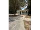 The front exterior features a yard with tree and ample driveway at 4617 John Bell Jr Dr, Tampa, FL 33610