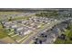 Overview showcasing a residential community with well-kept homes, lush greenery, and a scenic lake at 6438 Milestone Loop, Palmetto, FL 34221
