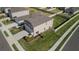 Aerial view of a well-maintained home with a spacious, green lawn and a classic suburban setting at 6438 Milestone Loop, Palmetto, FL 34221