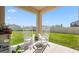 Back porch with serene rocking chairs overlooking a private backyard at 6438 Milestone Loop, Palmetto, FL 34221