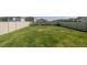 Large, fenced backyard with lush green grass and space for outdoor activities at 6438 Milestone Loop, Palmetto, FL 34221