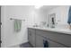 Bathroom featuring a double vanity with gray cabinets, quartz countertops, and modern fixtures at 6438 Milestone Loop, Palmetto, FL 34221