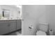Bathroom featuring a toilet, gray vanity, and double sinks at 6438 Milestone Loop, Palmetto, FL 34221