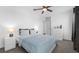 Bedroom featuring plush carpeting, a ceiling fan, and curtains for blocking sunlight at 6438 Milestone Loop, Palmetto, FL 34221
