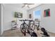 Neutral bedroom with a ceiling fan, window, television and exercise equipment for working out at 6438 Milestone Loop, Palmetto, FL 34221