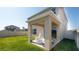 A covered patio featuring rocking chairs, an outdoor sitting area, and views of the yard at 6438 Milestone Loop, Palmetto, FL 34221