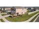 Expansive lawn surrounds this home with neutral siding, complemented by well-maintained landscaping at 6438 Milestone Loop, Palmetto, FL 34221