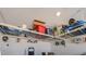 Garage with overhead storage racks to maximize space and organization at 6438 Milestone Loop, Palmetto, FL 34221