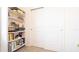 Hallway with a bookshelf and storage closet for organization at 6438 Milestone Loop, Palmetto, FL 34221