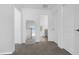 Hallway with neutral carpeting and white walls leads to bedrooms and bathrooms at 6438 Milestone Loop, Palmetto, FL 34221