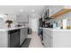 Modern kitchen features sleek grey cabinets, stainless steel appliances, and a stylish backsplash at 6438 Milestone Loop, Palmetto, FL 34221