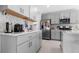 Bright kitchen with grey cabinets, quartz countertops, stainless steel appliances, and a charming backsplash at 6438 Milestone Loop, Palmetto, FL 34221