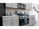 Contemporary kitchen design showcases stainless steel appliances, grey cabinetry, and sleek countertops at 6438 Milestone Loop, Palmetto, FL 34221