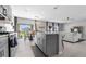 Well-designed kitchen with a central island, modern appliances, and an open view to the dining and living areas at 6438 Milestone Loop, Palmetto, FL 34221
