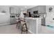 Kitchen island boasts barstool seating, ample counter space, and elegant grey cabinetry at 6438 Milestone Loop, Palmetto, FL 34221