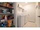 Laundry room featuring a washer and dryer, with shelving for organizing laundry supplies at 6438 Milestone Loop, Palmetto, FL 34221