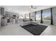 Open-concept living space featuring modern decor, tile flooring, gray walls, and a view of the backyard at 6438 Milestone Loop, Palmetto, FL 34221