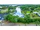 An aerial view showcases the canal-front community, mature trees, and inviting waterways at 9503 Alice Ln, Riverview, FL 33578